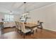 Open floor plan with dining table and chairs next to living room area with fireplace and sofa at 3030 Westpoint Cir, Snellville, GA 30078