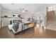 Open-concept living room with fireplace and TV; the hardwood floors connect to a modern kitchen at 3030 Westpoint Cir, Snellville, GA 30078