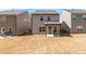 Back exterior of house featuring a covered patio and well-maintained lawn at 3040 Westgate Park Dr, Loganville, GA 30052