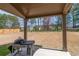 Covered patio with grill overlooking the spacious backyard at 3040 Westgate Park Dr, Loganville, GA 30052
