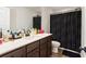 Bathroom features single vanity with brown cabinets, quartz counters and a shower/tub combo at 3040 Westgate Park Dr, Loganville, GA 30052