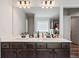 Modern bathroom featuring double vanity with dark wood cabinets and quartz countertops at 3040 Westgate Park Dr, Loganville, GA 30052