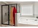 Bright bathroom features a soaking tub and a large glass shower with gray tiling at 3040 Westgate Park Dr, Loganville, GA 30052