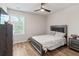 This neutral bedroom has a ceiling fan and an upholstered headboard at 3040 Westgate Park Dr, Loganville, GA 30052