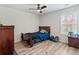 Spare bedroom features wood floors, natural light, and a ceiling fan at 3040 Westgate Park Dr, Loganville, GA 30052