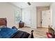 Bright bedroom features wood-look floors, neutral paint and a ceiling fan at 3040 Westgate Park Dr, Loganville, GA 30052