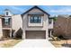 Charming exterior showcasing a well-maintained lawn, gray siding, and an attached two-car garage at 3040 Westgate Park Dr, Loganville, GA 30052