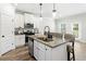 Stylish kitchen featuring an island with seating, stainless steel appliances and a walk-in pantry at 3040 Westgate Park Dr, Loganville, GA 30052