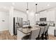 Modern kitchen with stainless steel appliances, granite countertops, and a kitchen island with seating at 3040 Westgate Park Dr, Loganville, GA 30052