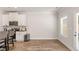 Bright eat-in kitchen with stainless steel appliances, countertop seating and wood-look floors at 3040 Westgate Park Dr, Loganville, GA 30052