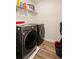 Laundry room featuring front loading LG washer and dryer, wire rack storage and utility sink at 3040 Westgate Park Dr, Loganville, GA 30052