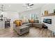 Open concept living room features cozy fireplace, plank floors, and contemporary furnishings at 3040 Westgate Park Dr, Loganville, GA 30052