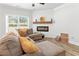 Comfortable living room with cozy fireplace and plush sectional sofa for relaxing at 3040 Westgate Park Dr, Loganville, GA 30052