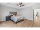 Spacious main bedroom features tray ceiling, neutral decor, wood flooring and an ensuite bathroom at 3040 Westgate Park Dr, Loganville, GA 30052