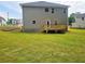 Spacious backyard with newly laid sod and a small wooden deck, perfect for outdoor entertaining at 305 Melanie Ct, Bowdon, GA 30108