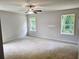 Spacious bedroom featuring two windows offering natural light and a ceiling fan for comfort at 305 Melanie Ct, Bowdon, GA 30108