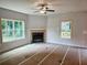 Cozy living room with a fireplace and large windows offering plenty of natural light at 305 Melanie Ct, Bowdon, GA 30108