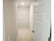 Bright walk-in closet features white wire shelving, and ample space for storage at 305 Melanie Ct, Bowdon, GA 30108