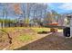 Large backyard with mature trees, a patio dining area, and a fire pit for entertaining at 1011 Dogwood Forest Ne Dr, Marietta, GA 30068