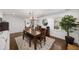 Elegant dining area with a large wooden table, bench seating, and ample natural light at 1011 Dogwood Forest Ne Dr, Marietta, GA 30068