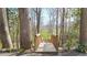 Rustic wooden footbridge surrounded by mature trees and lush greenery, offering a charming pathway at 1011 Dogwood Forest Ne Dr, Marietta, GA 30068