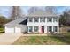 Charming white home with a red door, gray shutters, and a well-manicured front yard at 1011 Dogwood Forest Ne Dr, Marietta, GA 30068
