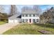 A well-maintained white home with a two-car garage and a vibrant red front door at 1011 Dogwood Forest Ne Dr, Marietta, GA 30068