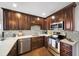 Stylish kitchen with dark wood cabinets, stainless steel appliances, and a mosaic backsplash at 1011 Dogwood Forest Ne Dr, Marietta, GA 30068