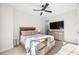 Bedroom featuring a modern ceiling fan, a comfortable bed, and a dresser with television at 269 Castleberry Station Dr, Atlanta, GA 30313