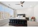 A modern bedroom features a unique leather bed frame and bright natural lighting from a large window at 269 Castleberry Station Dr, Atlanta, GA 30313