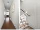 Bright hallway with natural light and hardwood floors, leading to bedrooms and stairway at 269 Castleberry Station Dr, Atlanta, GA 30313