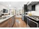 Modern kitchen with stainless steel appliances and sleek counter tops overlooking the living room at 269 Castleberry Station Dr, Atlanta, GA 30313