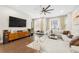 Comfortable living room with modern entertainment center, decorative rug, and contemporary ceiling fan at 269 Castleberry Station Dr, Atlanta, GA 30313