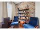 Stylish sitting area with exposed brick wall and built-in shelving with bar setup at 269 Castleberry Station Dr, Atlanta, GA 30313