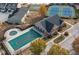 Aerial view showcasing the community center, pool with cover, and tennis courts surrounded by beautiful autumn trees at 2960 Fareed St, Douglasville, GA 30135