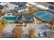 A beautiful aerial view of a community center featuring a pool, tennis courts, parking, and attractive landscaping at 2960 Fareed St, Douglasville, GA 30135