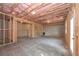 Unfinished basement with exposed framing, insulation, concrete floor, and an exterior door at 2960 Fareed St, Douglasville, GA 30135