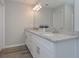 Bright bathroom features a double vanity with granite counters, white cabinets and modern fixtures at 2960 Fareed St, Douglasville, GA 30135