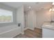 Bright bathroom with double vanity, soaking tub, and glass-enclosed shower at 2960 Fareed St, Douglasville, GA 30135