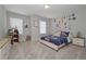 bedroom with carpet, two windows with blinds, bed, dresser and bookshelf at 2960 Fareed St, Douglasville, GA 30135