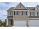 Charming townhome featuring a two-car garage and classic brick facade at 2960 Fareed St, Douglasville, GA 30135