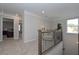 Second story landing with seating area and wrought iron railings provides an overlook to a bedroom at 2960 Fareed St, Douglasville, GA 30135