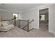 Upstairs hallway that features a seating area and decorative metal railings with a view to a bedroom at 2960 Fareed St, Douglasville, GA 30135