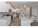 Modern kitchen features white cabinets, stainless steel appliances, and a granite island with seating at 2960 Fareed St, Douglasville, GA 30135