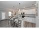 A well-lit kitchen with granite countertops, an island with seating, and white cabinets, open to the breakfast nook at 2960 Fareed St, Douglasville, GA 30135