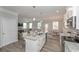 Bright kitchen with granite countertops and an island with seating that transitions into dining and living areas at 2960 Fareed St, Douglasville, GA 30135