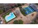 Aerial view of a pool and pickleball courts in a neighborhood with lake access at 330 Teal Ct, Roswell, GA 30076