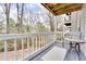Relaxing balcony featuring a table with chairs and views of the woods at 330 Teal Ct, Roswell, GA 30076