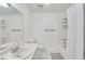 Bright bathroom featuring a large mirror, shower with curtain, and a tiled floor at 330 Teal Ct, Roswell, GA 30076