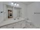 Bathroom featuring a large mirror, vanity with storage, and a tiled floor at 330 Teal Ct, Roswell, GA 30076